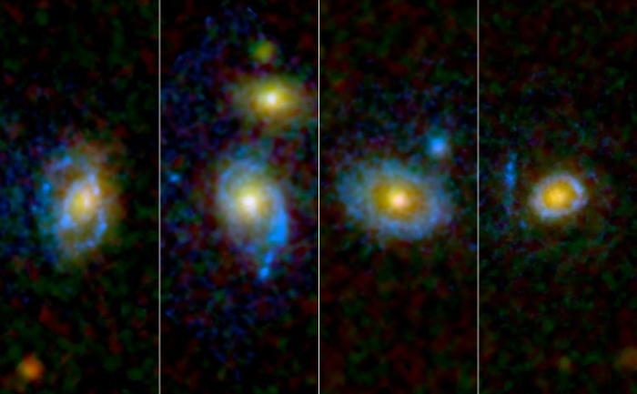 Astronomii au gasit inele neasteptate si arce de raze ultraviolete imprejurul unor galaxii. Patru dintre ele sunt infatisate aici in imaginea capturata de telescopul Hubble al NASA