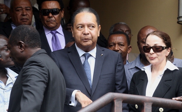 Jean-Claude Duvalier (C), fostul dictator haitian, luat in custodia politiei, impreuna cu sotia sa, Veronique Roy (D), la Hotel Karibe 18 ianuarie 2011 in Port-au-Prince, Haiti. (Mario Tama / Getty Images)