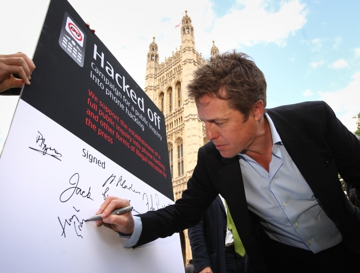 Actorul Hugh Grant semneaza in sprijinul campaniei 'Hacked off' desfasurata in fata parmamentului, pe 6 iulie 2011.