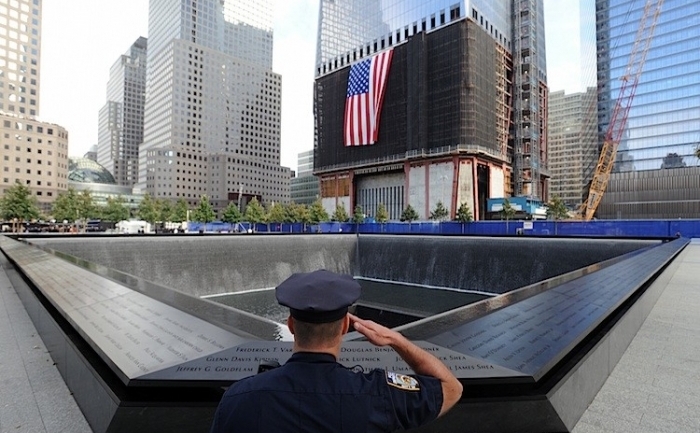 Danny Shea, ofiter al Departamentului de politie din New York si militar veteran, saluta in fata Memorialului 9/11 in timpul ceremoniilor ocazionate de cea de-a 10-a comemorare a atacurilor teroriste din 11 septembrie 2011 asupra World Trade Center. (David Handschuh-Pool / Getty Images)