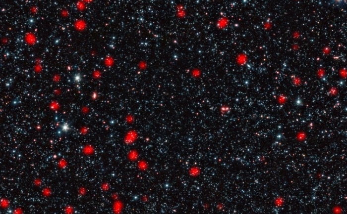 Galaxii îndepărtate manifestă procese neobişnuite de formare de noi stele, cunoscute sub numele de explozii stelare (MPIfR / ESO / OSO, A. Weiss et al., NASA Spitzer Science Center)