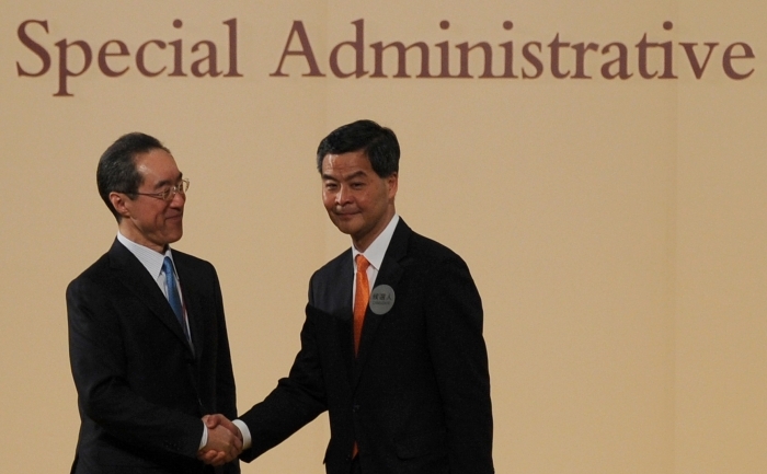 Şeful executiv ales al Hong Kong, Leung Chun-Ying (dr), strânge mâna cu celălalt candidat pe acelaşi post, Henry Tang, înaintea anunţării viitorului şef executiv pe 25 martie 2012. (aaron tam / AFP / Getty Images)