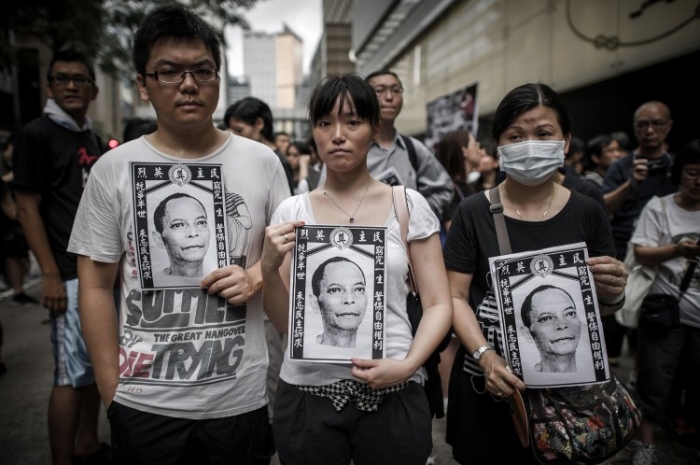 Protestatari la marşul de protest organizat după moartea suspectă a dizidentului chinez Li Wangyang - Hong Kong 10 iunie.