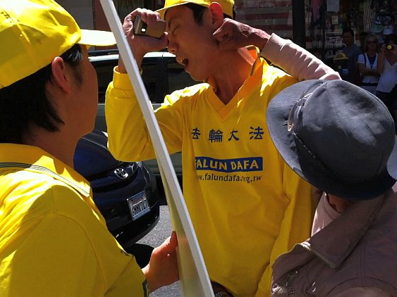 Yongyao Wu (dreapta) îl atacă pe Derek Wang, aderent Falun Gong, în cartierul chinez din San Francisco, 10 iunie. Wu a fost condamnat pe 13 august