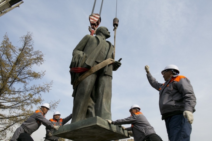 A crane lifts the statue of Vladimir Lenin as workers help to remove it Oct. 14, in Ulan Bator, Mongolia. The mayor of Ulan Bator decided to take down the Soviet era statue because it represented the repression of the Soviet years.
