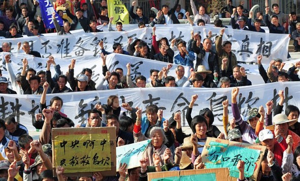 Sătenii ţin banere în timpul unui miting de protest din Wukan, provincia Guangdong, la 19 decembrie 2011 şi le solicită autorităţilor centrale să ia măsuri privind confiscarea ilegală de teren şi moartea unui lider local în custodie. Un an mai târziu, sătenii declară că nu sunt mulţumiţi de modul în care s-au rezolvat lucrurile.