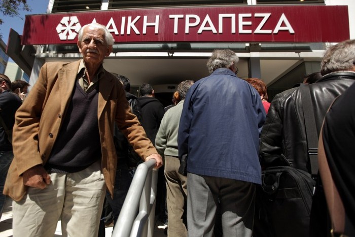 Oamenii s-au pus la coadă în faţa unei sucursale a Băncii Laiki din capitala cipriotă, în Nicosia, la 8 martie 2013 şi aşteapată ca banca să se deschidă după 12 zile de inactivitate. (Patrick Baz / AFP / Getty Images)