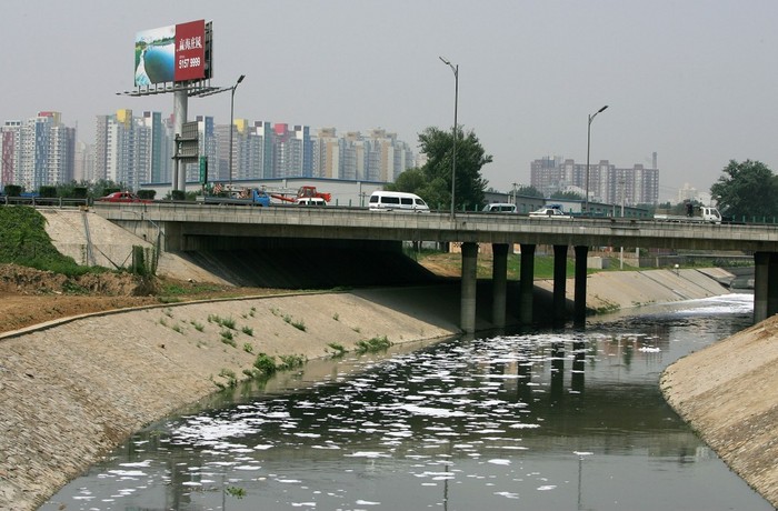 Apele industriale reziduale se varsă în râul Bei Xiaohe, în Beijing, China. Poluarea apei este o problemă gravă de mediu în China şi contribuie la ratele ridicate de cancer.