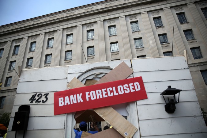 Activiştii protestează în faţa Departamentul de Justiţie al Statelor Unite la 20 mai 2013, în Washington, DC. Proprietarii de case şi activişti protestează pentru a cere ca Băncile de pe Wall Street care au devastat economia Americii fie trase la răspundere.