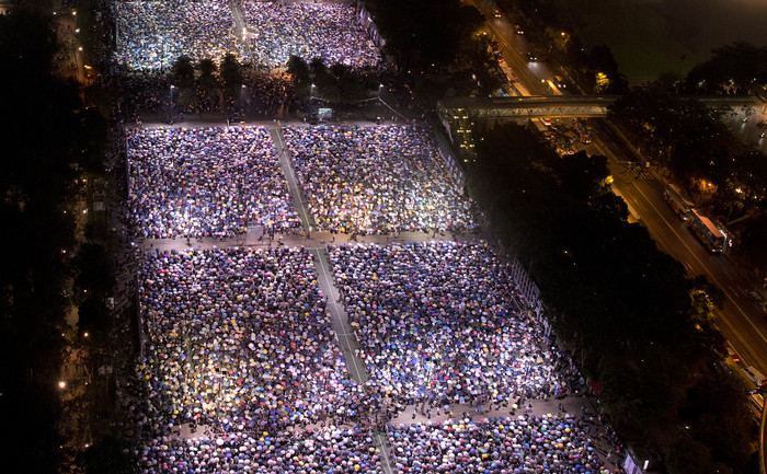 People are seen gathered at Victoria Park during a candlelight vigil held to mark the 24th anniversary of the 1989 crackdown at Tiananmen Square, in Hong Kong on June 4, 2013.  More than 100,000 people were expected to attend the candlelight vigil in the former British colony which is the only place in China where the brutal military intervention that ended weeks of nationwide democracy protests in 1989 is openly commemorated.  AFP PHOTO /  Alex Ogle        (Photo credit should read Alex Ogle/AFP/Getty Images) (Alex Ogle / AFP / Getty Images)