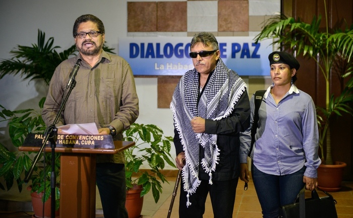 Revolutionary Armed Forces of Colombia (FARC) Commander, Ivan Marquez (L), gives a speech at the Convention Palace in Havana as peace talks with the Colombian government resume on August 19, 2013. At center Commander Jesus Santrich, at right Maritza Garcia. Colombia holds a new round of talks with leftist FARC rebels nine months after the two sides relaunched a peace process aimed at ending Latin America's longest-running insurgency.  AFP PHOTO/ADALBERTO ROQUE        (Photo credit should read ADALBERTO ROQUE/AFP/Getty Images)