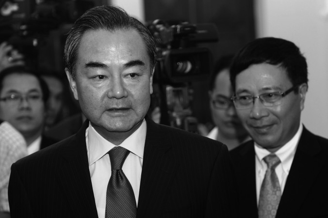 Chinese Foreign Minister Wang Yi (C) in Vietnam on Aug. 4, 2013. Wang said that China keeps a close eye on Syria; state media recently warned the United States from a military intervention, after the use of chemical weapons was reported. (Hoang Dinh Nam / AFP / Getty Images)