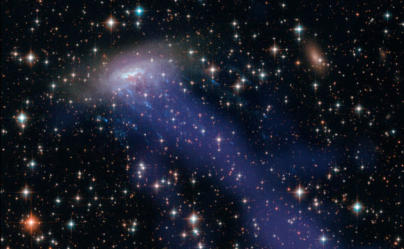 Galaxia spiralată ESO 137-001 străpunge prin conglomeratul de galaxii Norma.