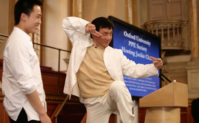 Jackie Chan într-o postură de Kung Fu, pe scenă, împreună cu beizadeaua Bo Guagua, fiul fostlui boss de partid Bo Xilai, acum condamnat pe viaţă - Oxford University în 2008.