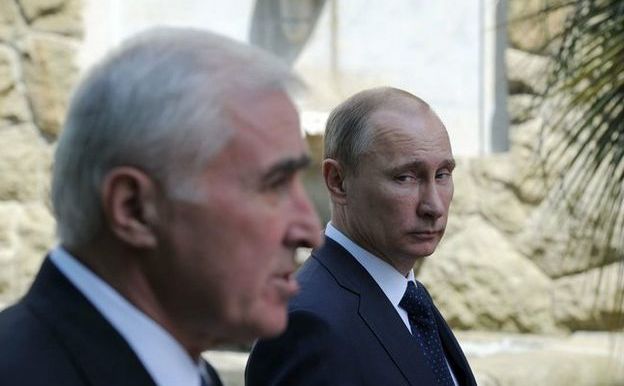 Preşedintele rus Vladimir Putin (în plan secund) şi liderul Osetiei de Sud, Leonid Tibilov. (Captură Foto)