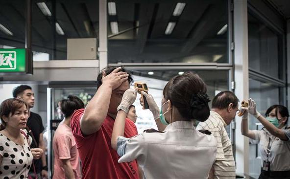Pasagerilor de la Aeroportul Internaţional din Hong Kong li se verifică temperatura ca parte măsurilor luate pentru a împiedica răspândirea virusului MERS, 5 iunie 2015. (Captură Foto)