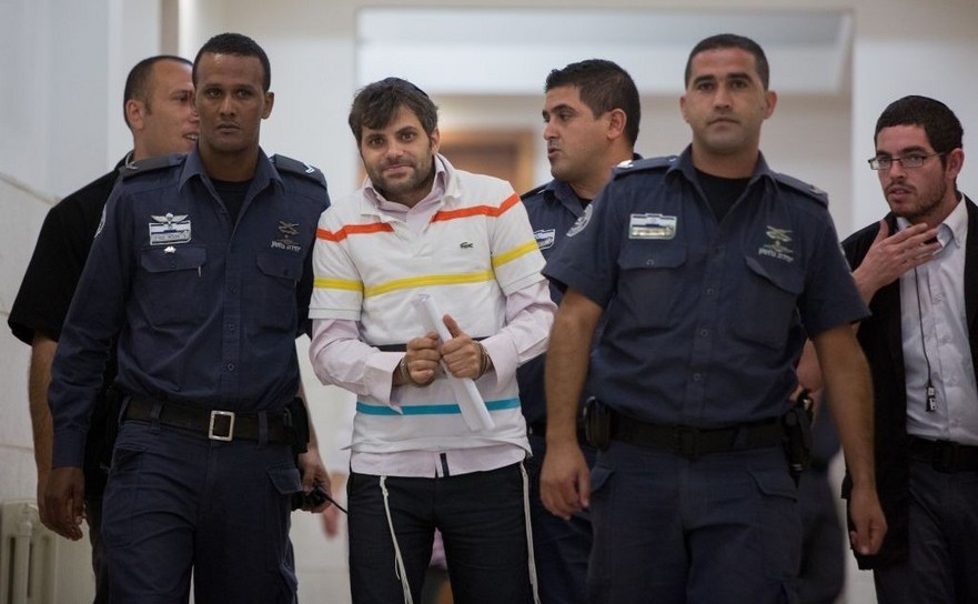 Poliţia  îl escortă pe Yosef Haim Ben-David, unul dintre evreii suspectaţi de  uciderea palestinianului Mohammed Abu Khdeir, în tribunalul districtual  din Ierusalim.
