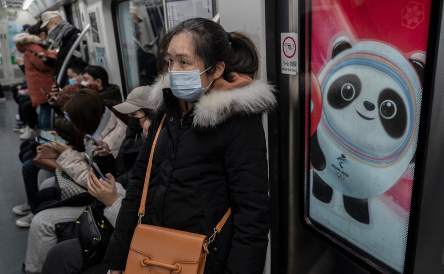 Locuitori din Beijing în metrou, lângă Bing Dwen Dwen, mascota JO de Iarnă 2022. 13 ianuarie 2022